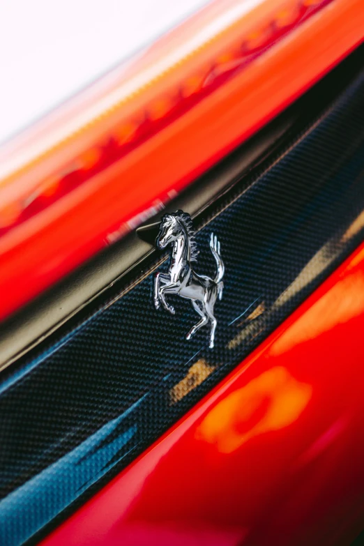 the horse emblem on the side of a red sports car