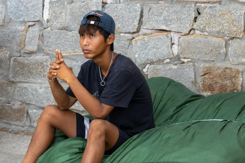 a  with a hat sitting on top of a bean bag chair