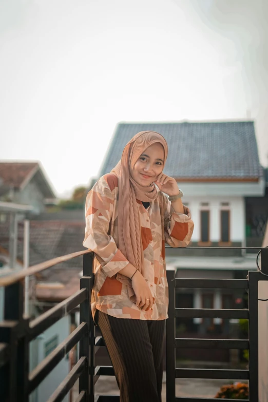 a woman standing on a balcony leaning against a railing