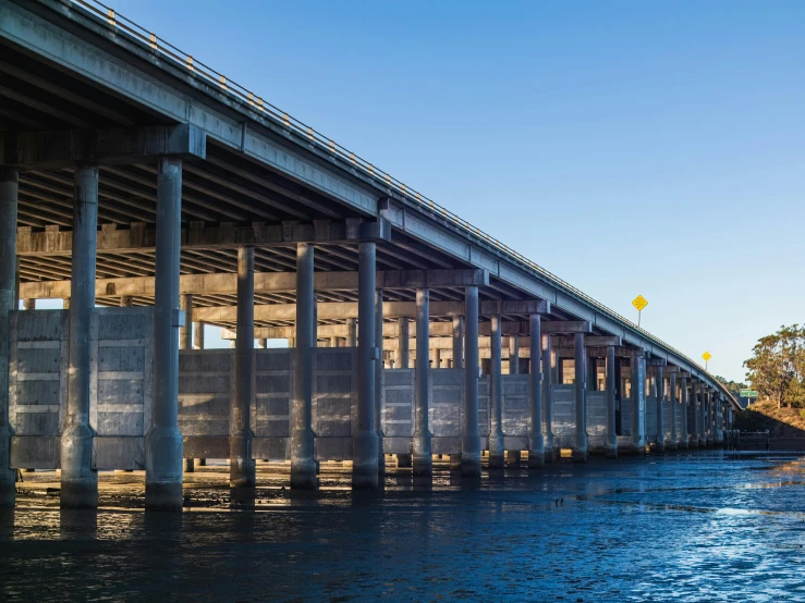 a bridge with columns over the water