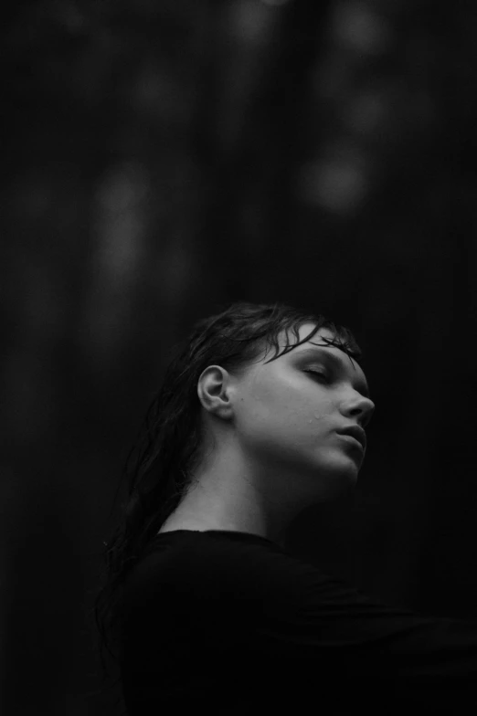 a woman in a black top and trees in the background