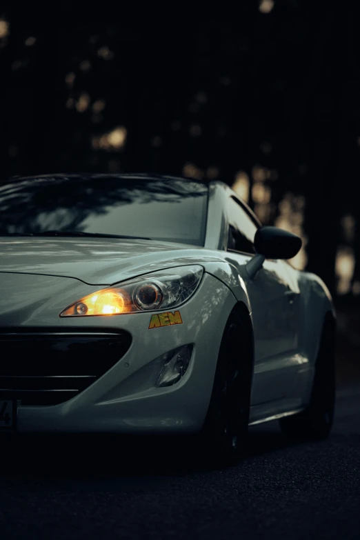 a silver car that is parked on the side of a road