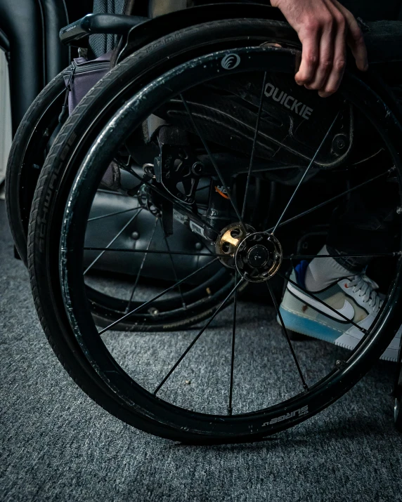 a person wearing a wheelchair with a broken wheel
