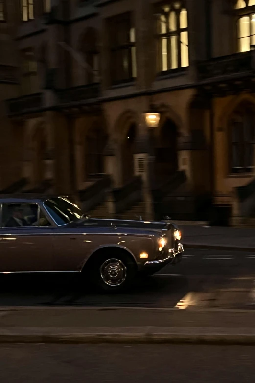 an old car on the street at night