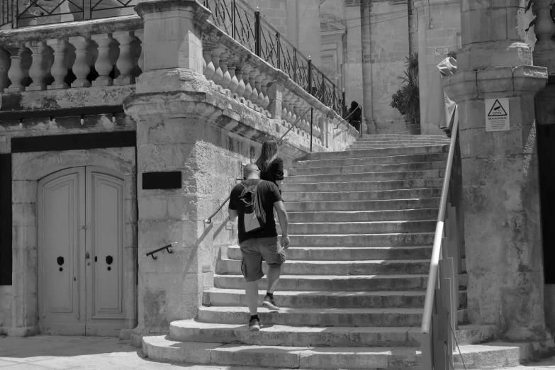 the man is walking up the steps in the old town