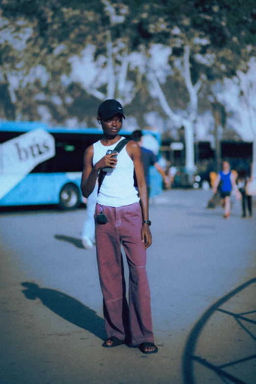 a man riding a skateboard next to a blue bus