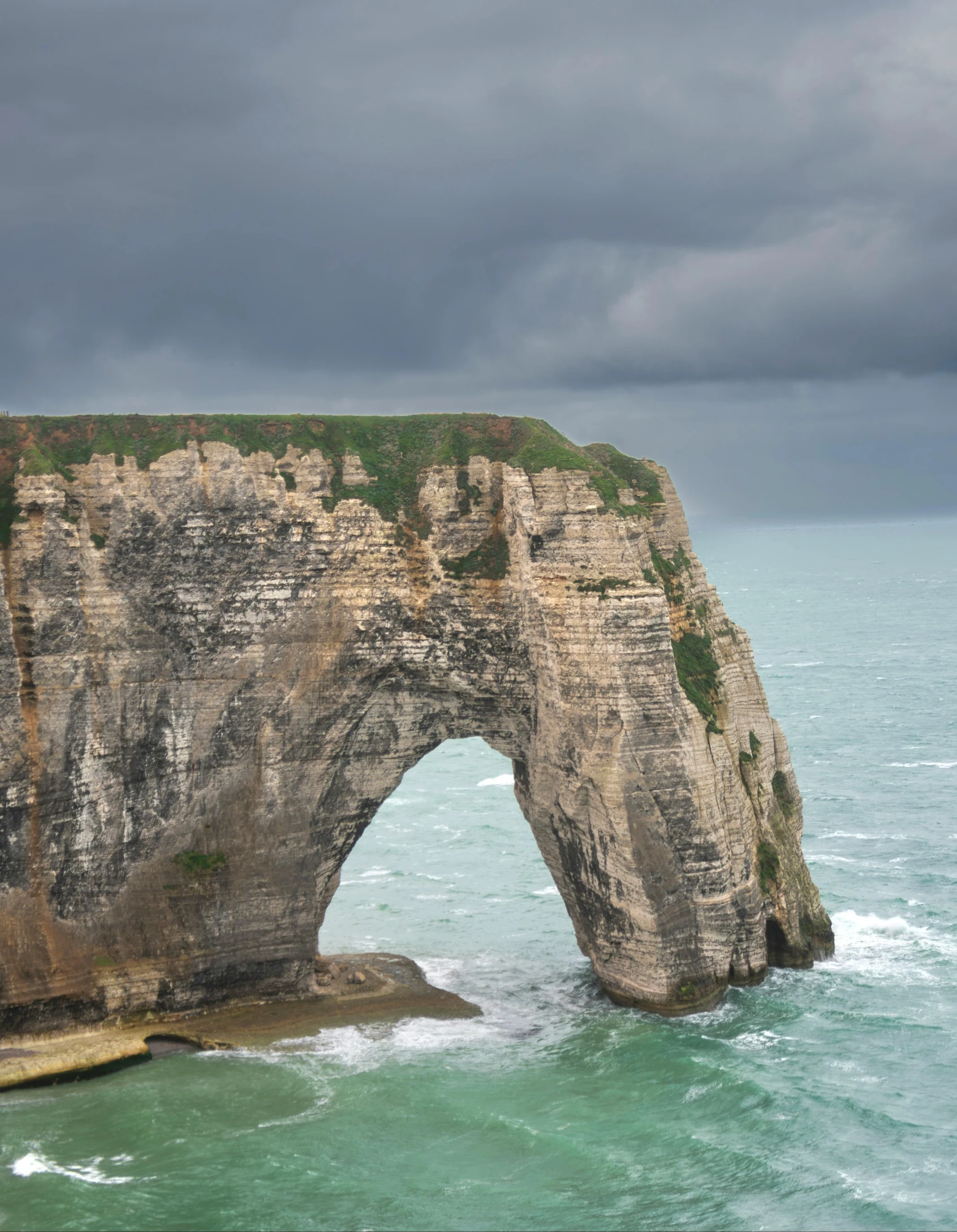 there is a large rock in the ocean