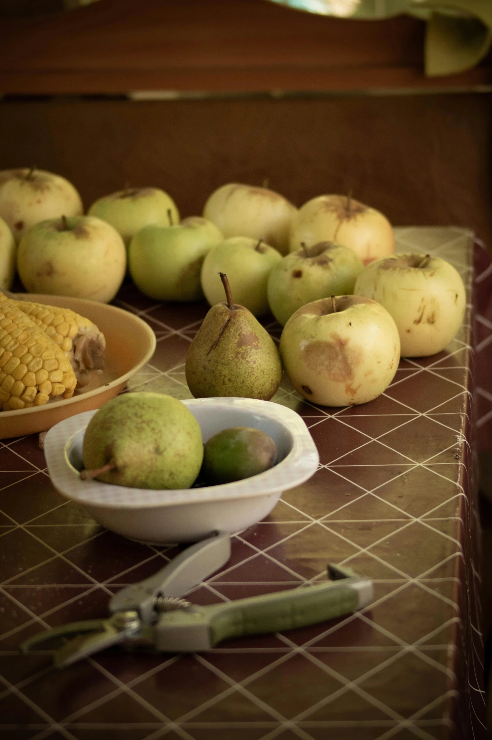 pears and corn on the cob are on the table