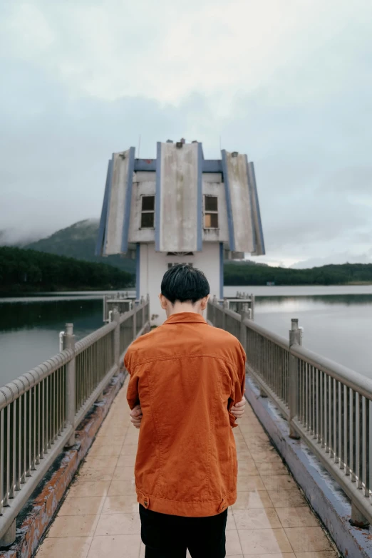 a person on a bridge that has water behind them