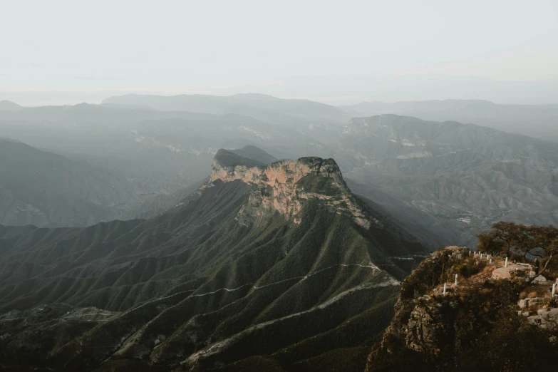 the mountainside has many green mountains and there are no trees