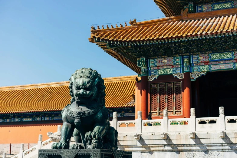 a lion statue sitting in front of a building