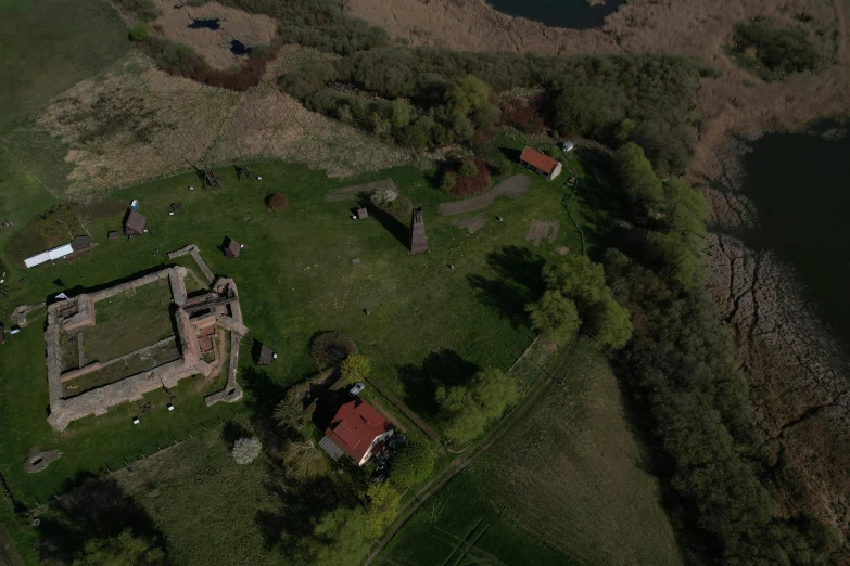 an aerial view of a large building next to some water