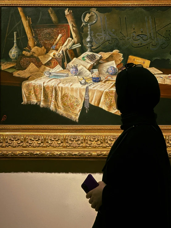 a person is looking at some artwork in a museum
