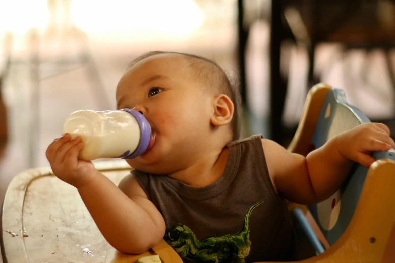 the baby has a bottle in its mouth