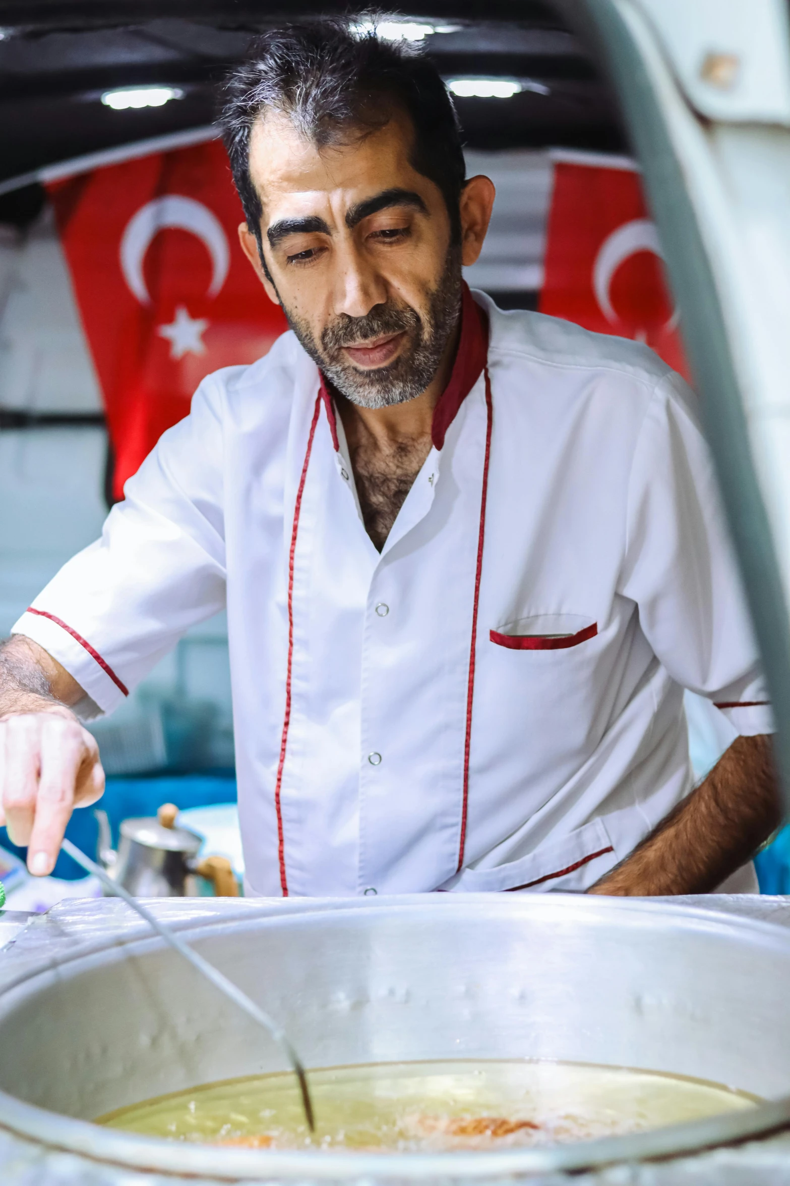 a man putting some kind of meat in a pot