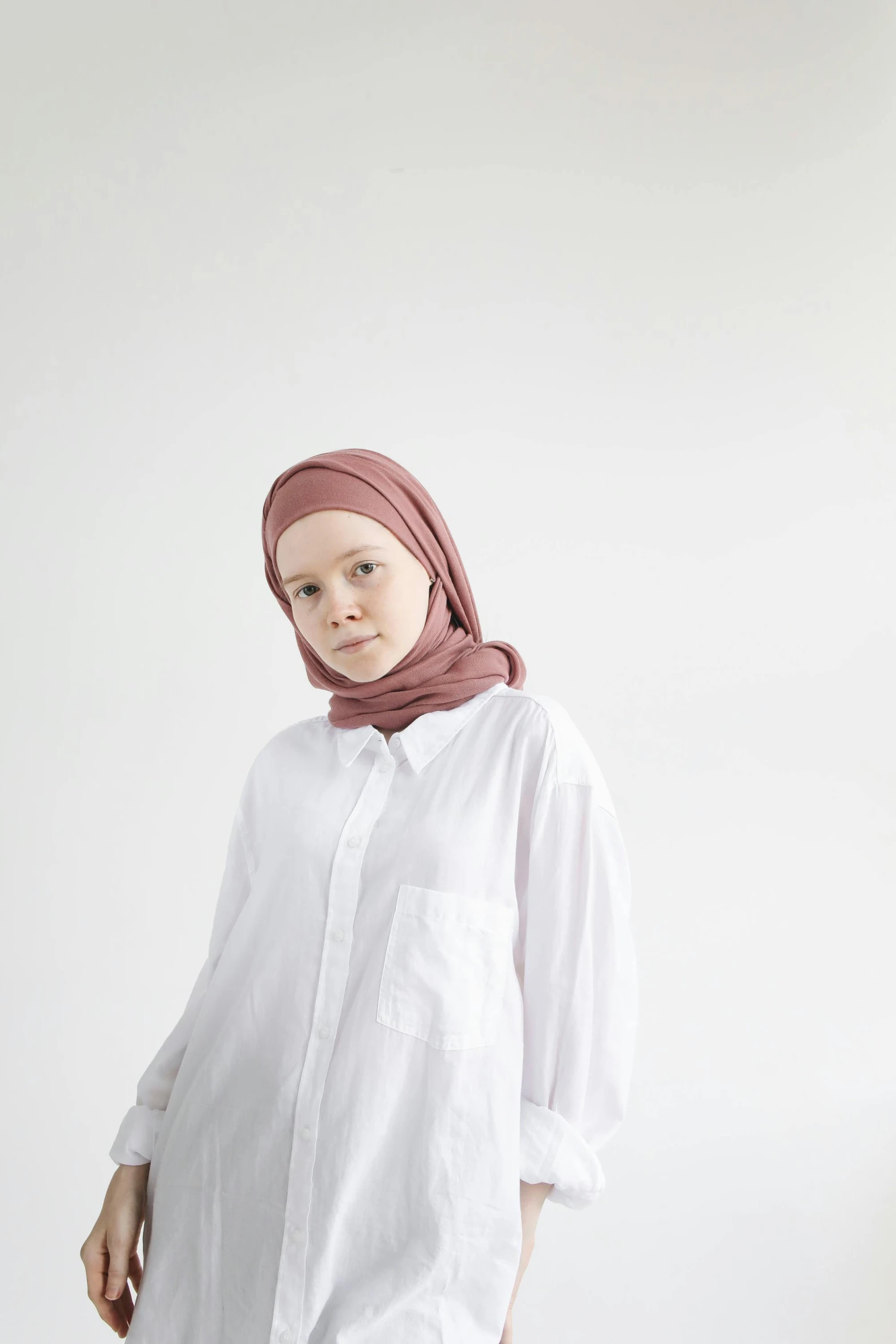 a  with a hijab and white shirt