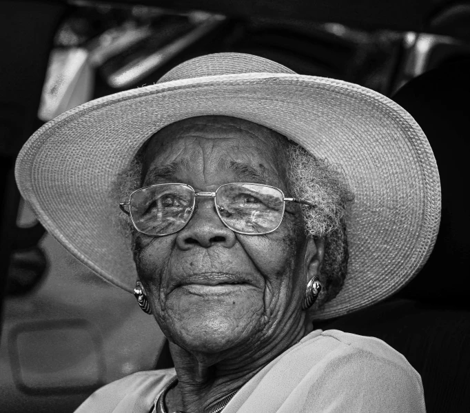 black and white pograph of an older woman wearing a big hat