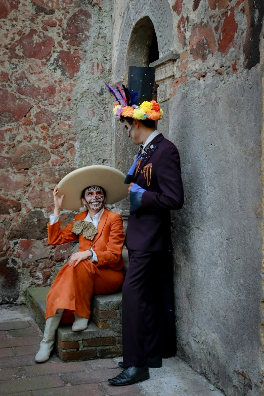 a man and a woman wearing orange clothes