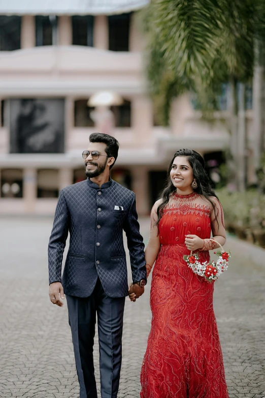 a man and a woman walking down the street holding hands