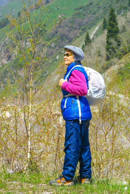 a person with a big backpack standing near some trees