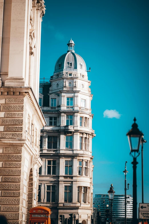 a tall white building with a sky in the background