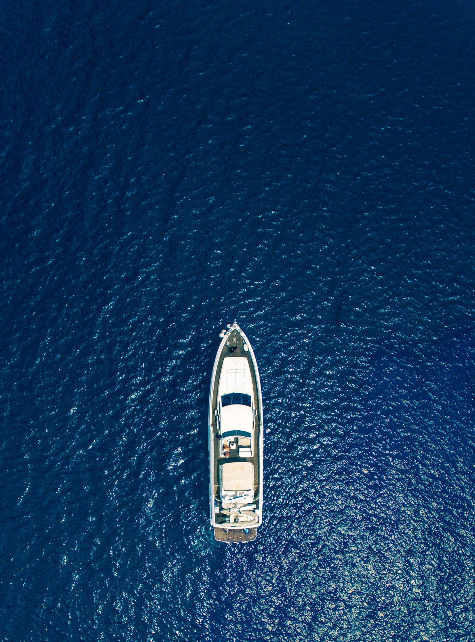 a small sailboat sailing in the ocean