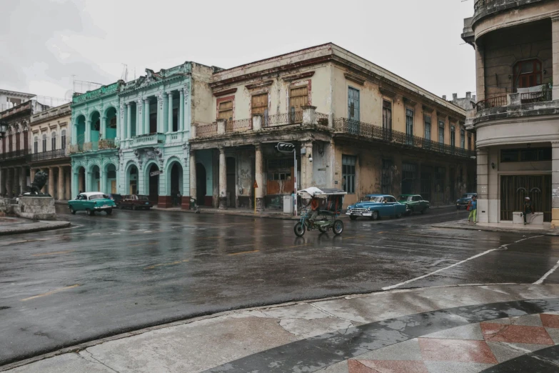 two old buildings sitting on the side of a road