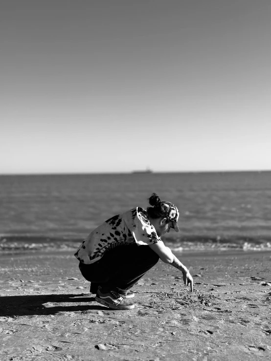 a person laying in the sand on a beach