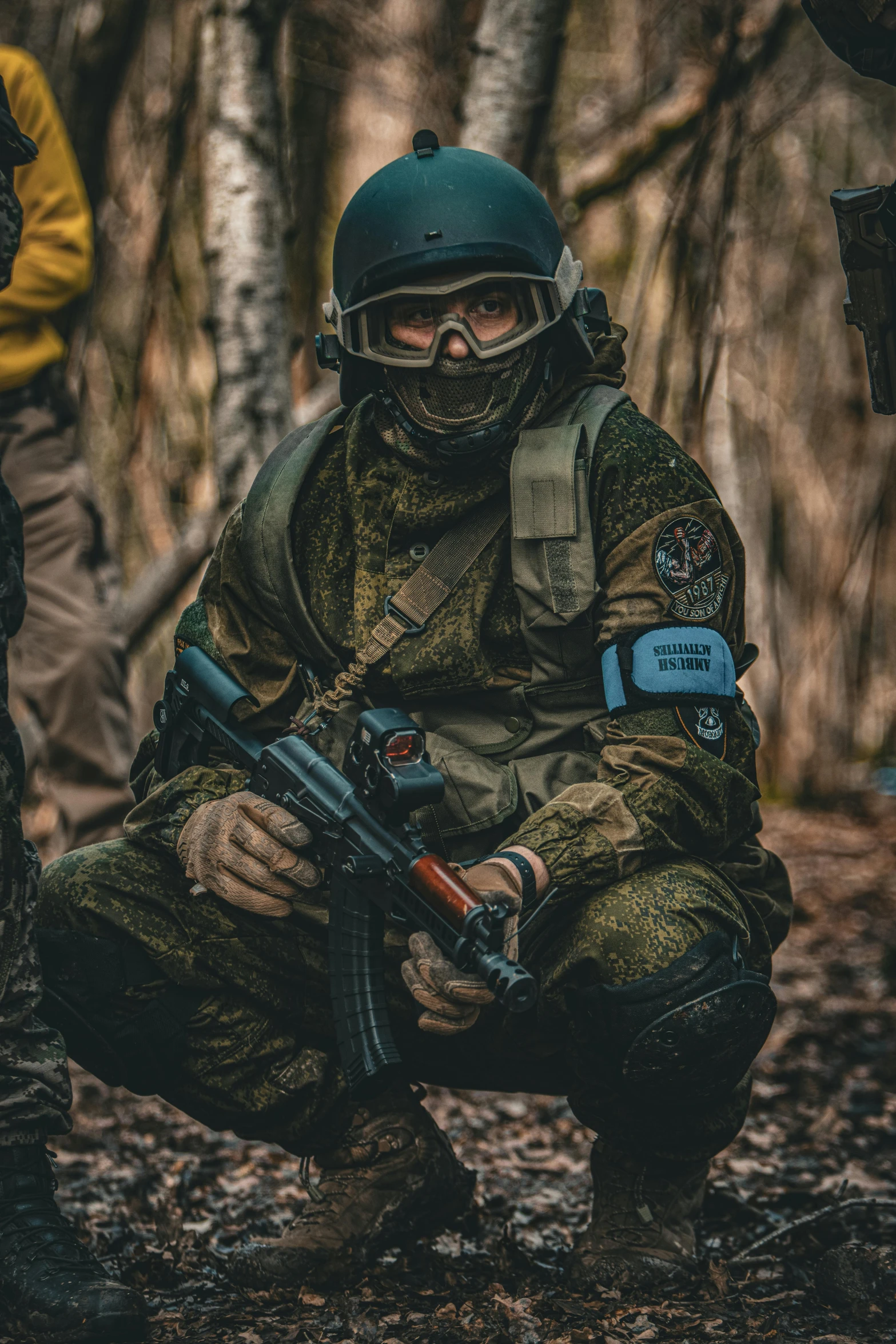 a person kneeling down with a machine gun