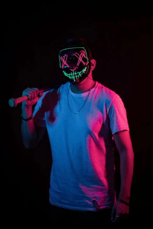 a man standing in a dark room holding a baseball bat