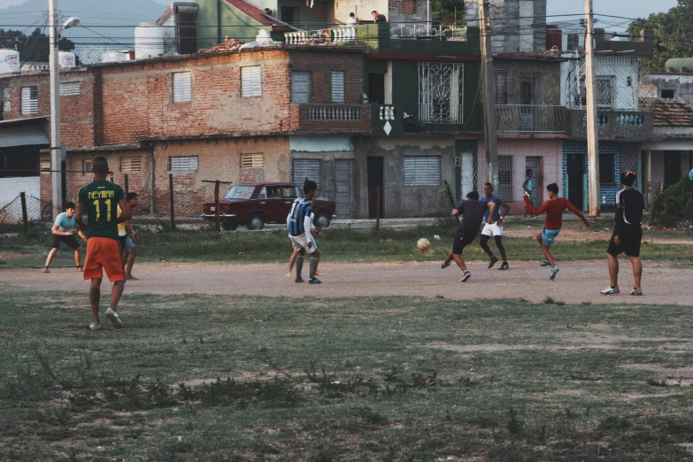 the people are playing soccer in the field