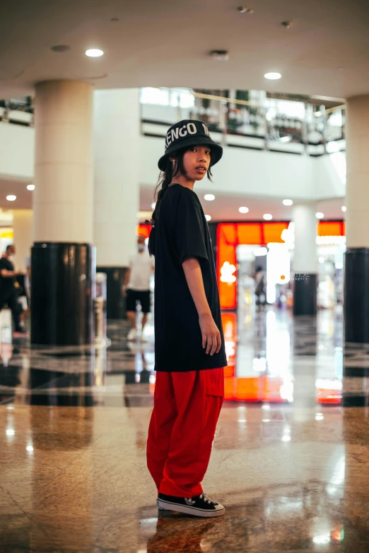 a boy standing in a large, clean lobby