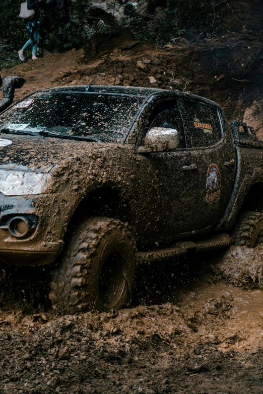 a dirt truck with its wheels sticking out in mud