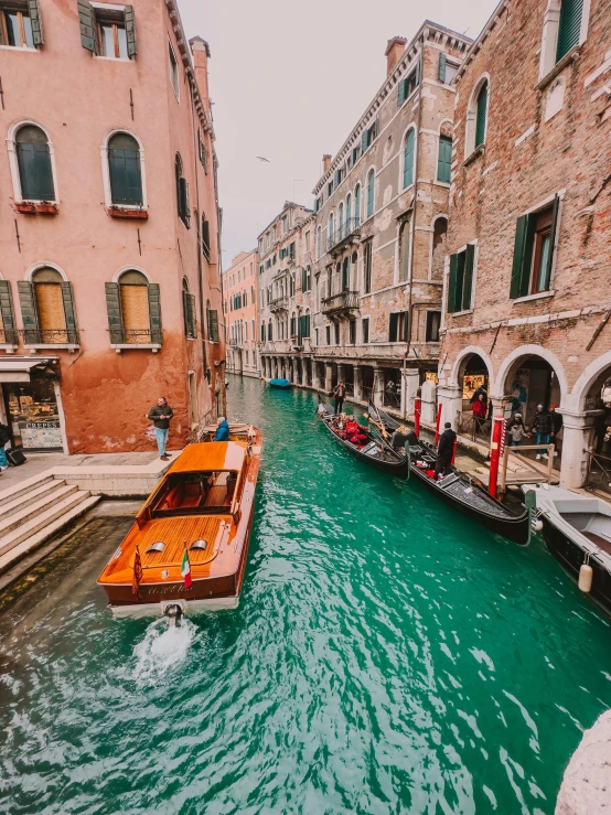 boats parked in the channel next to houses and a boat