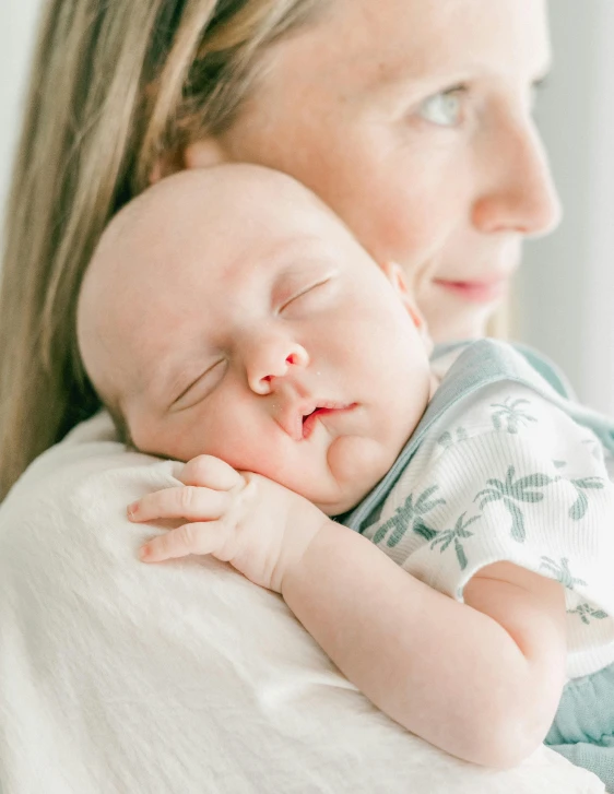 a mother hugging her newborn baby at the time of birth