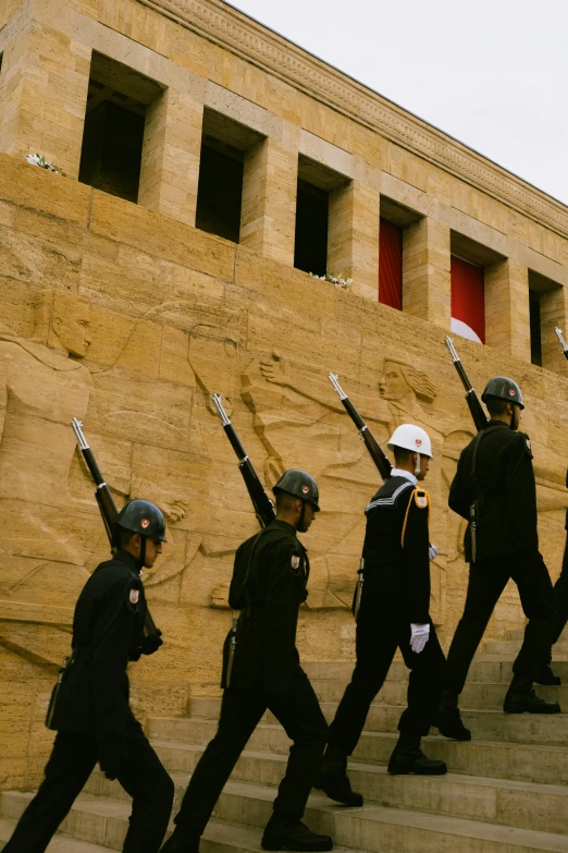 police officers standing on the steps outside with weapon in hand