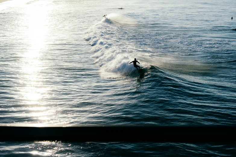 a person on a surf board rides in the water