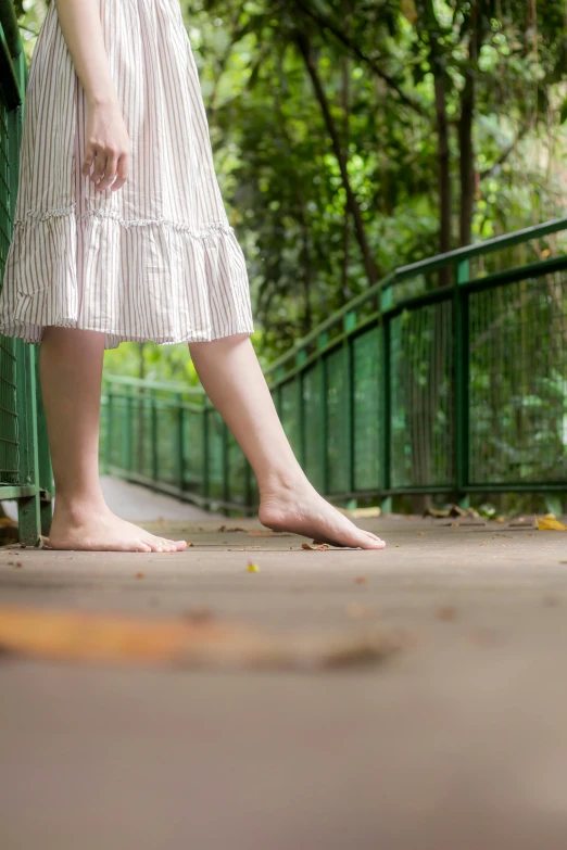 a close up of a woman's feet in front of trees