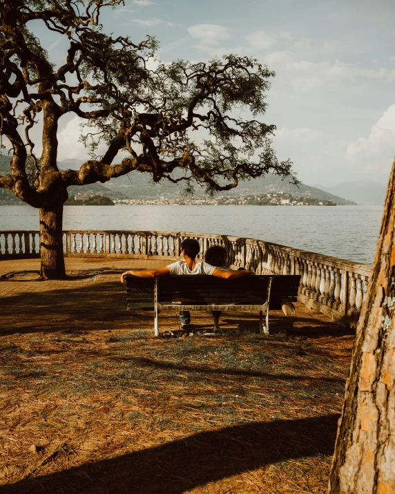 two people are lying down on a bench