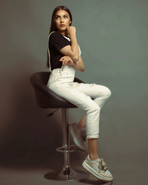 woman posing on a stool with her legs crossed