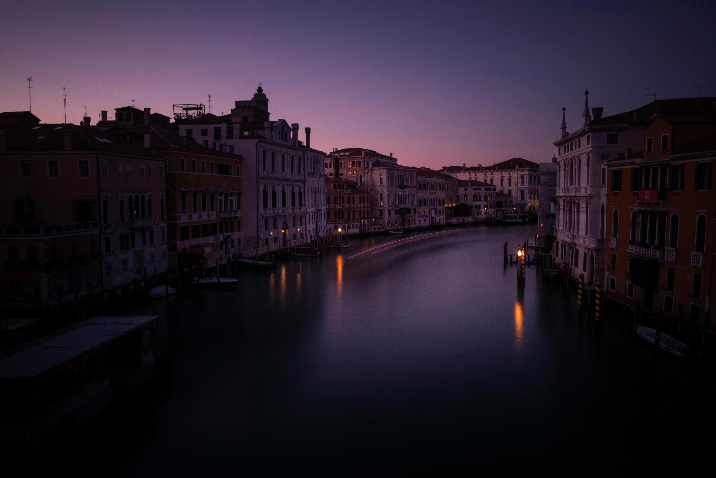 a body of water surrounded by city buildings