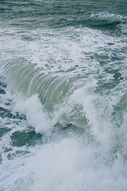 waves crashing against a stone coastline in the ocean