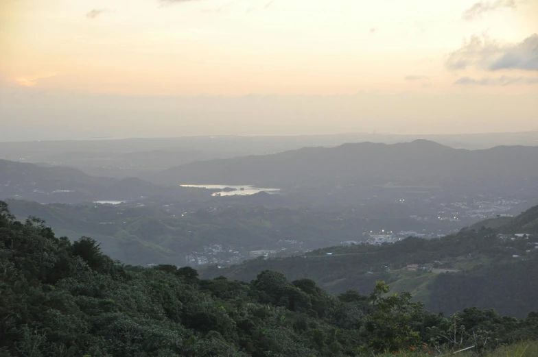 a landscape of some hills, a lake, and trees