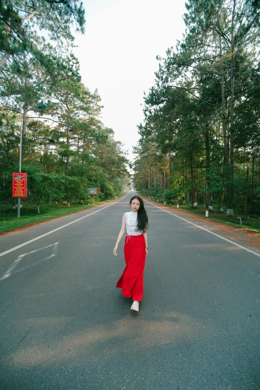 a woman in red and white is standing on a street