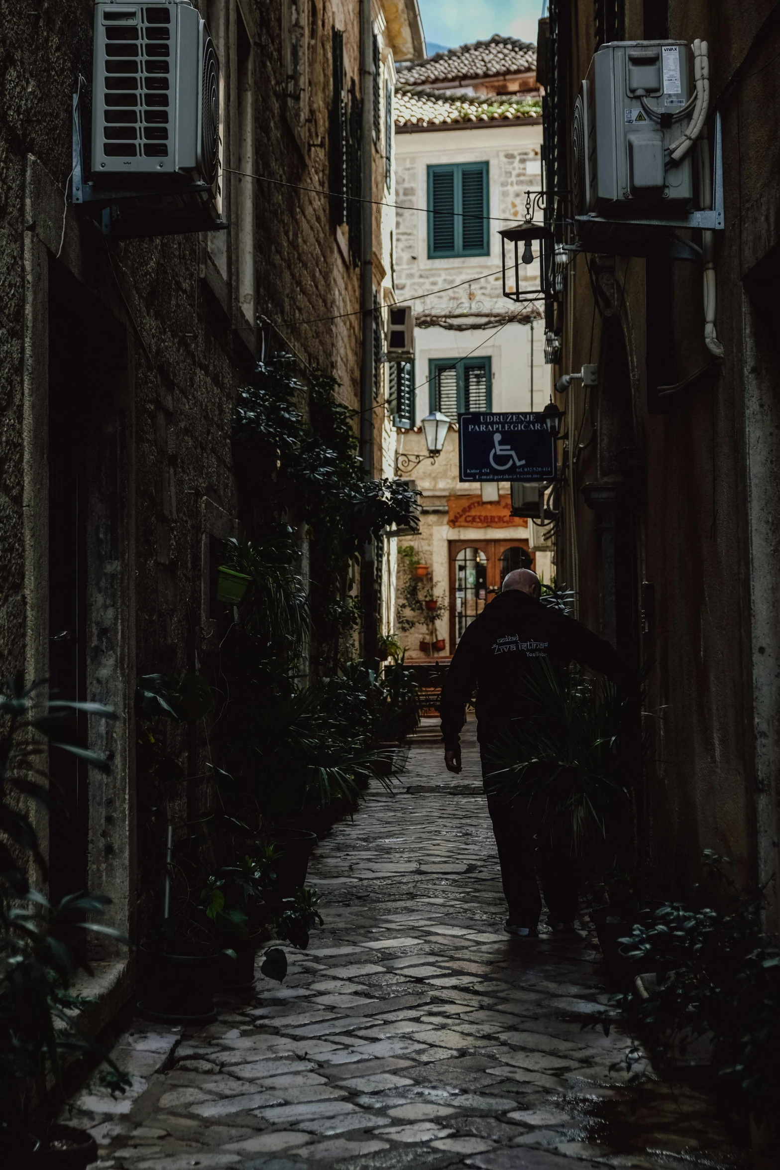 a dark alley way with a person walking