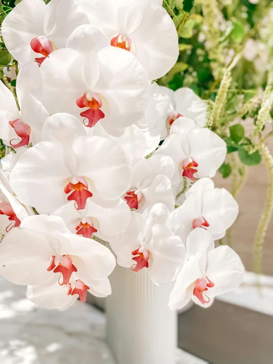 a close up of a vase with a bunch of flowers