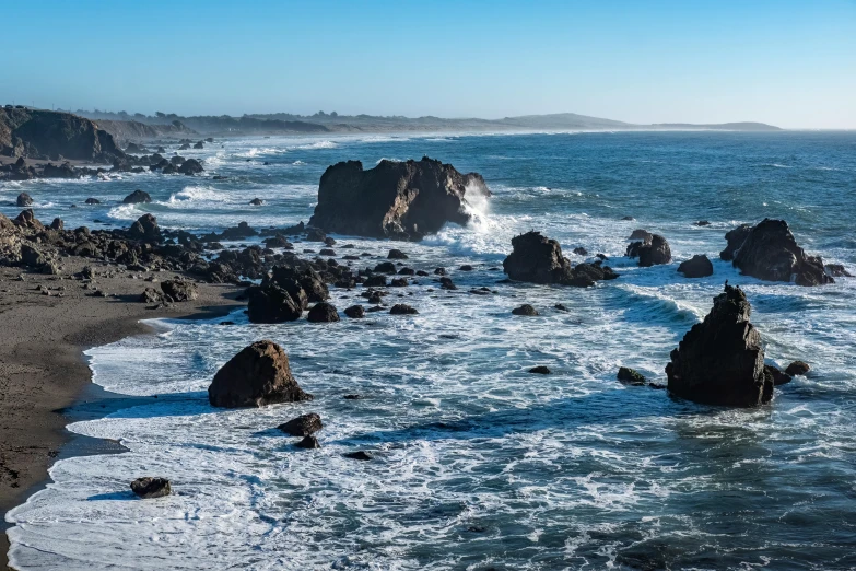 a view of the coast with many rocks in it