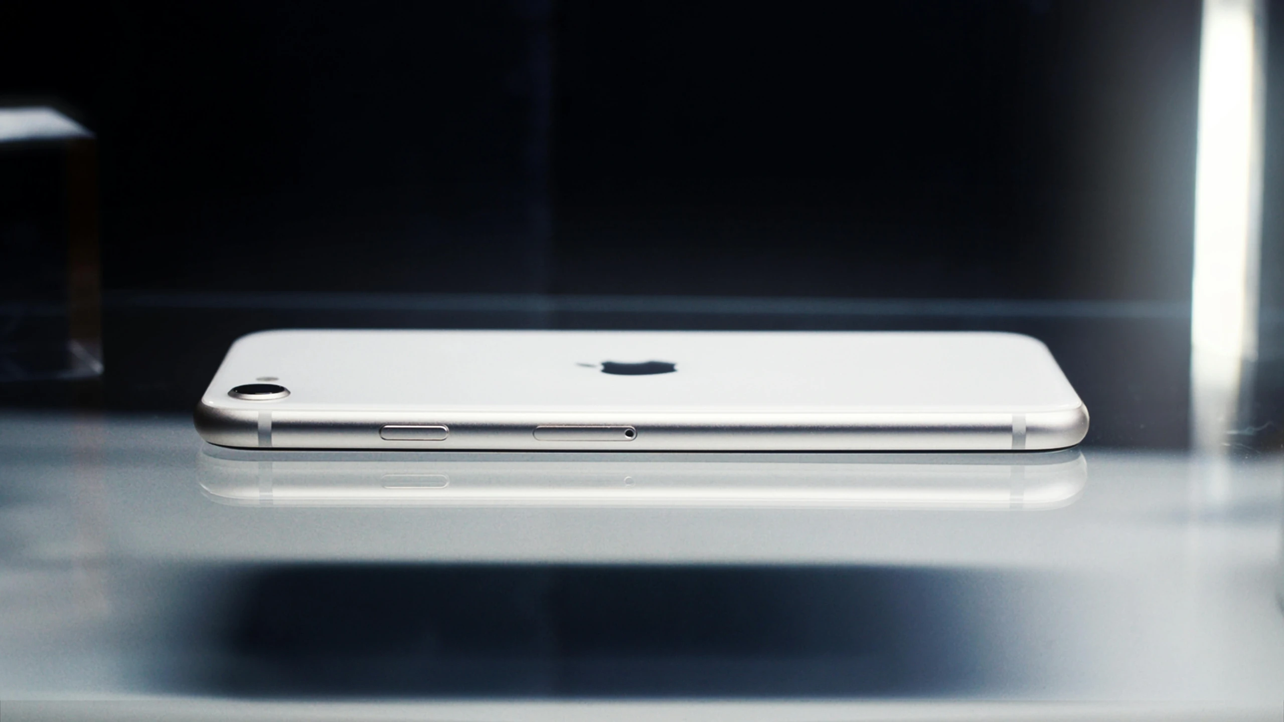 an iphone sitting on a table with its light reflected off of the screen