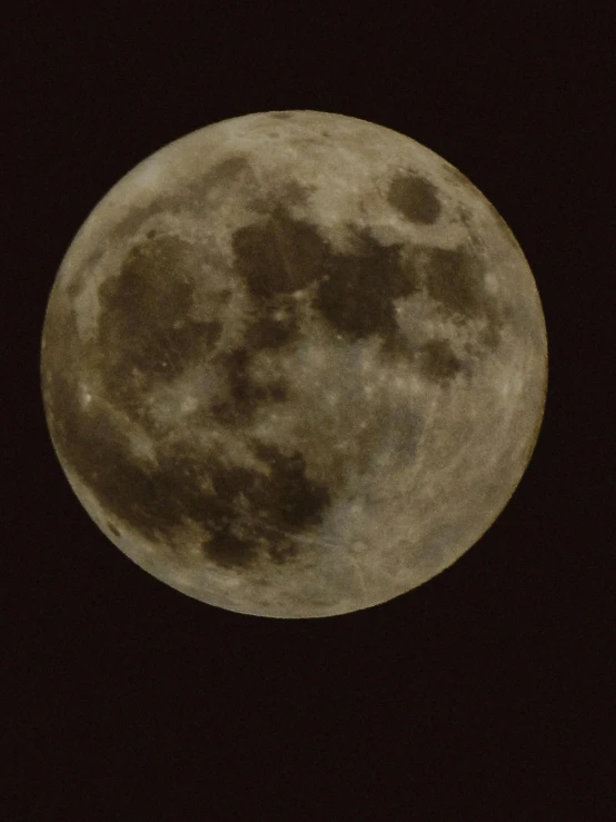 the full moon is seen in a black sky