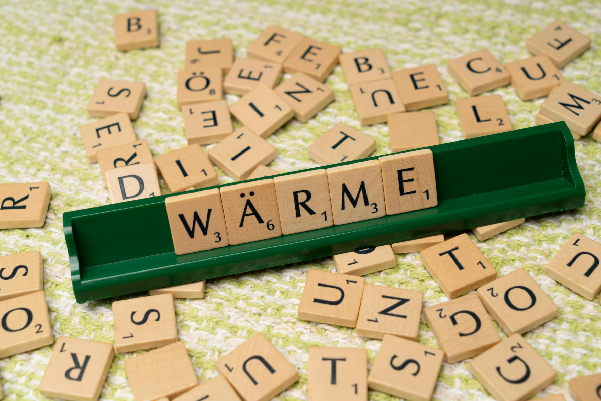 scrabble letters spelling the word warm and a block type word warm